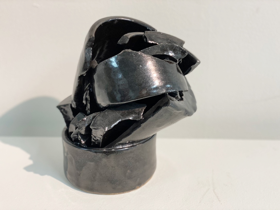 Black glazed broken pieces inside a black bowl